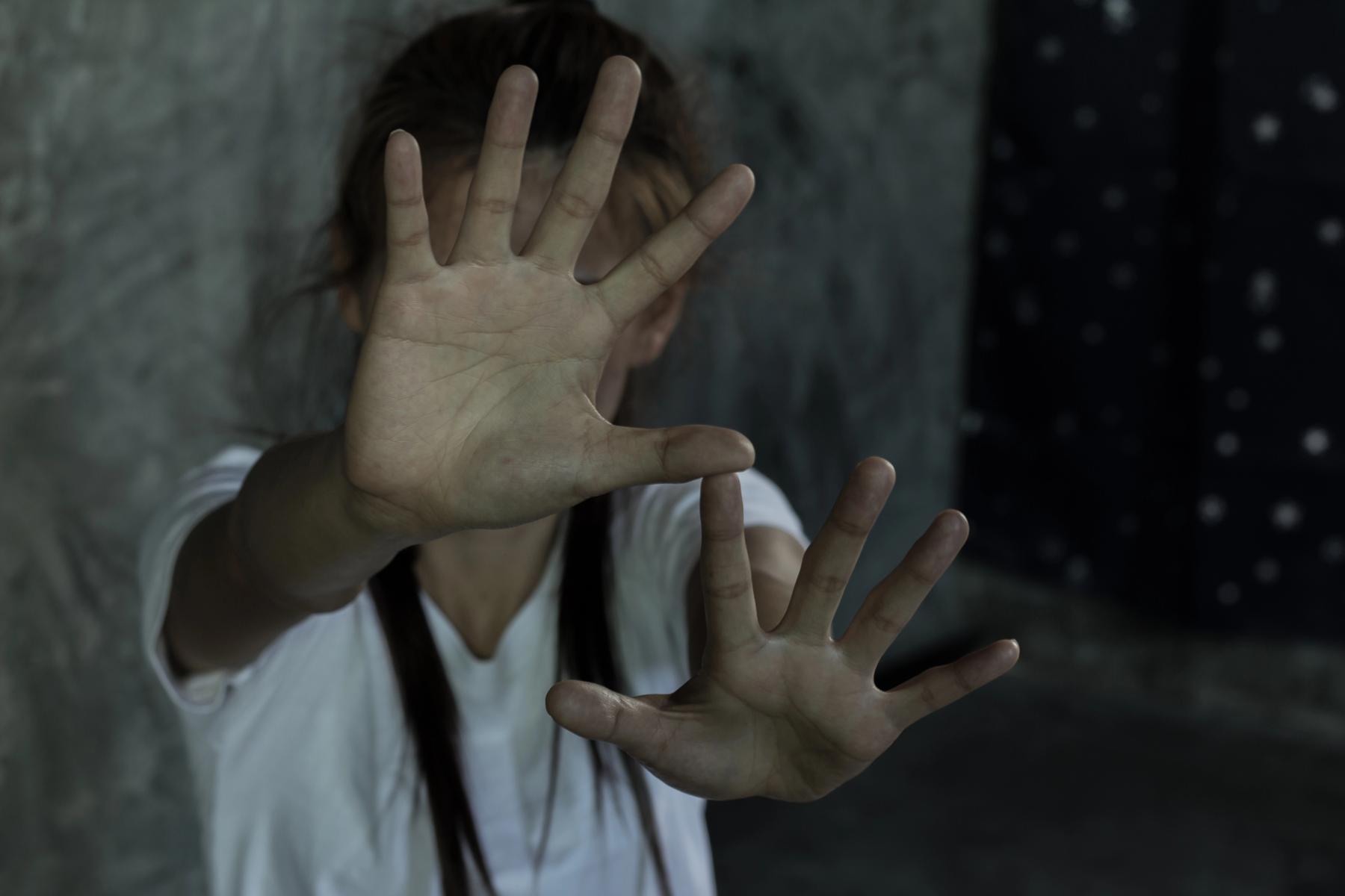 A girl holding up her hands to say stop